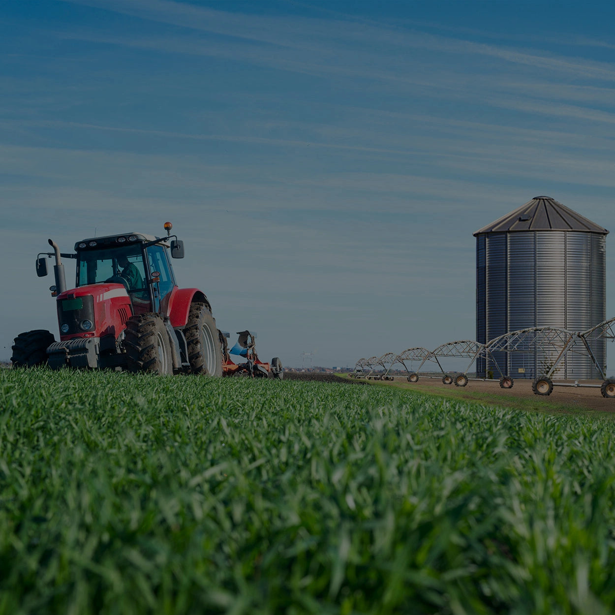 Tractor harvesting crops demonstrating the metals used for the architectural business