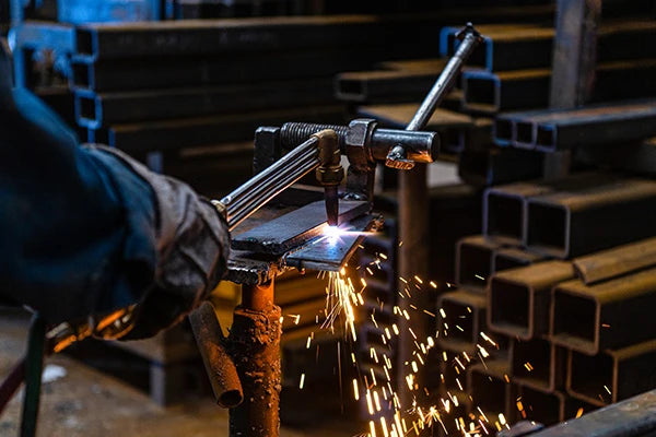 Man welding and fabricating metal.