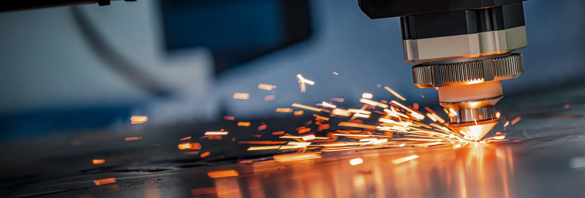 Flat Sheet Metal Laser cutting process with sparks in a manufacturing setting