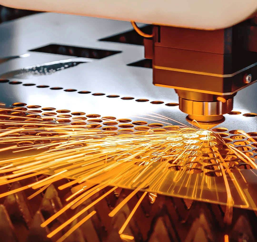 Laser cutting machine in action with sparks on a metallic surface
