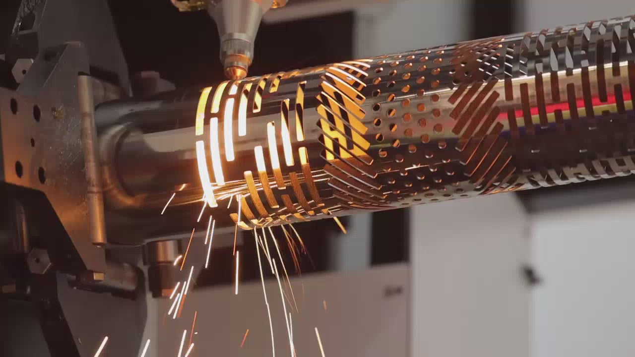 Tube laser cutting round steel with perforations and sparks flying