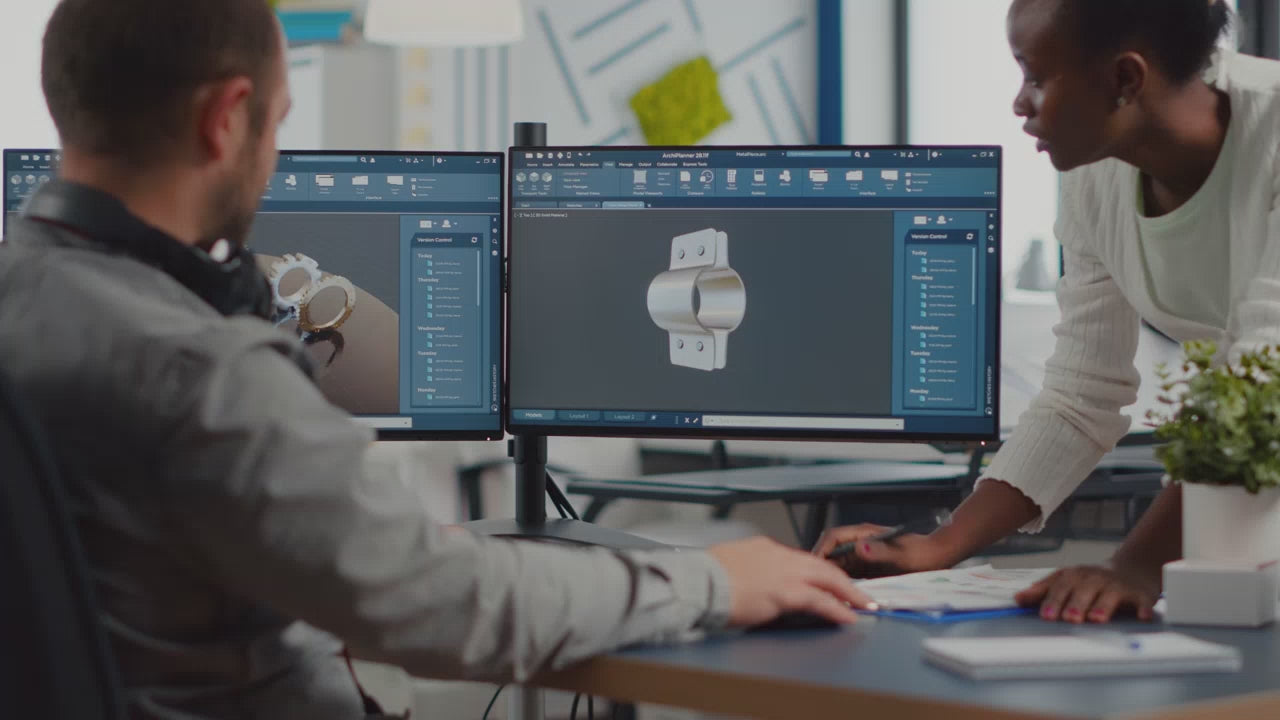 Colleagues looking at a CAD CAM drawing together in AutoDesk for the manufacturing industry